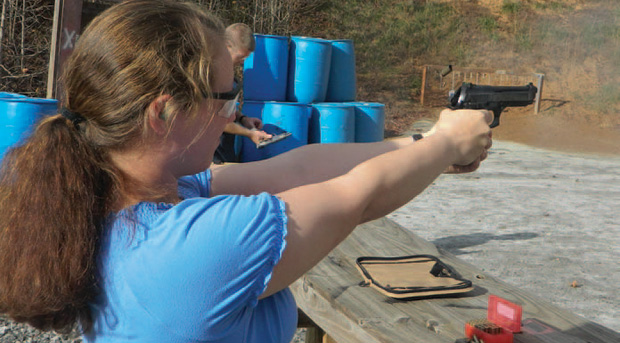mastering-the-doube-action-pistol-emily-campbell Emily Campbell blasting away with the full size Taurus 9mm pistol. She has mastered the type through long practice.
