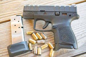 Black Beretta APX carry subcompact concealed carry pistol lying on an untreated deck next to an empty magazine and 11 spent 9mm brass casings.