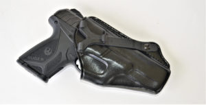 A black Ruger Security-9 semiautomatic pistol encased in a black leather holster from Galco Gunleather