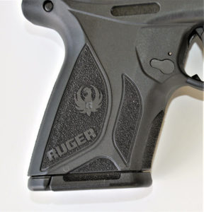 Detail of the textured grip on a Ruger Security-9 compact 9mm concealed carry pistol.