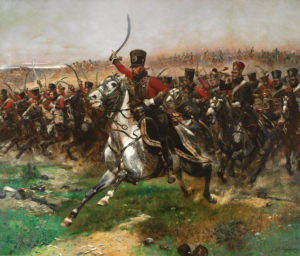 A painting called "Vive L'Empereur" painted in 1891 by Edouart Detaille. The image depicts the 4th Hussars cavalry in red uniform, fur hats and with curved sabers charging across a battlefield on horses.