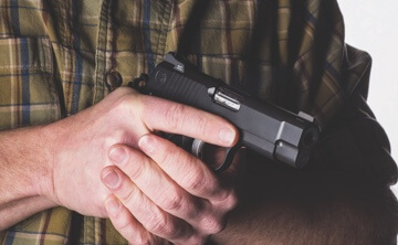 Two hands gripping pistol